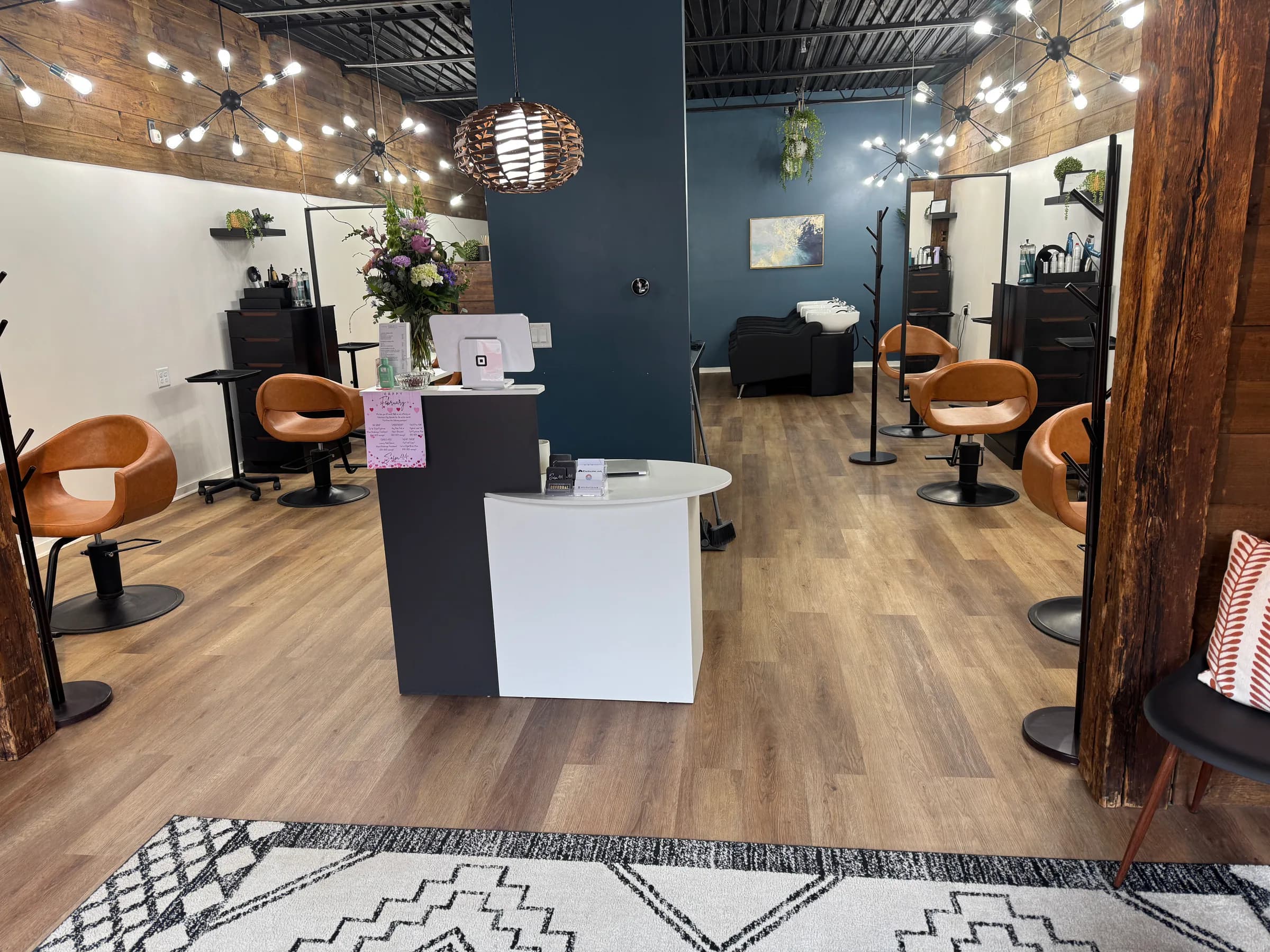 Salon 414 styling floor with natural wood details