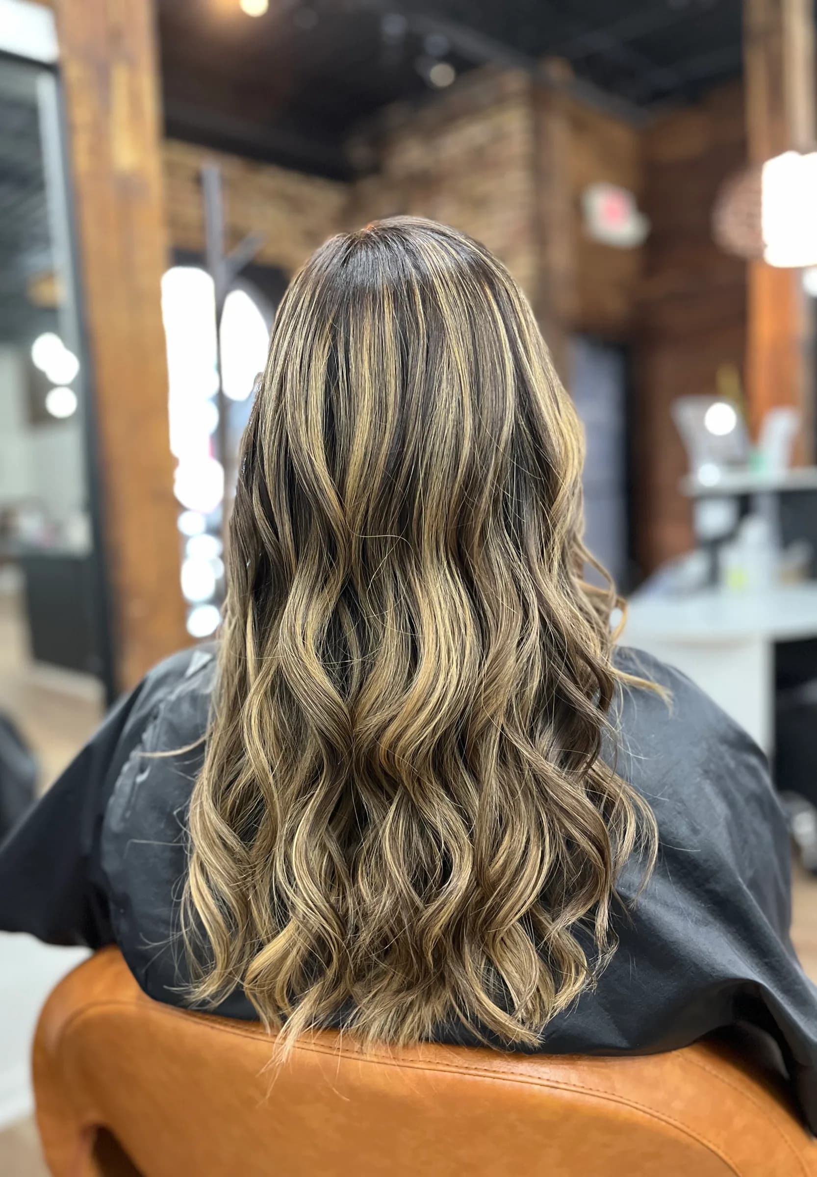 Soft blonde balayage highlights styled in waves
