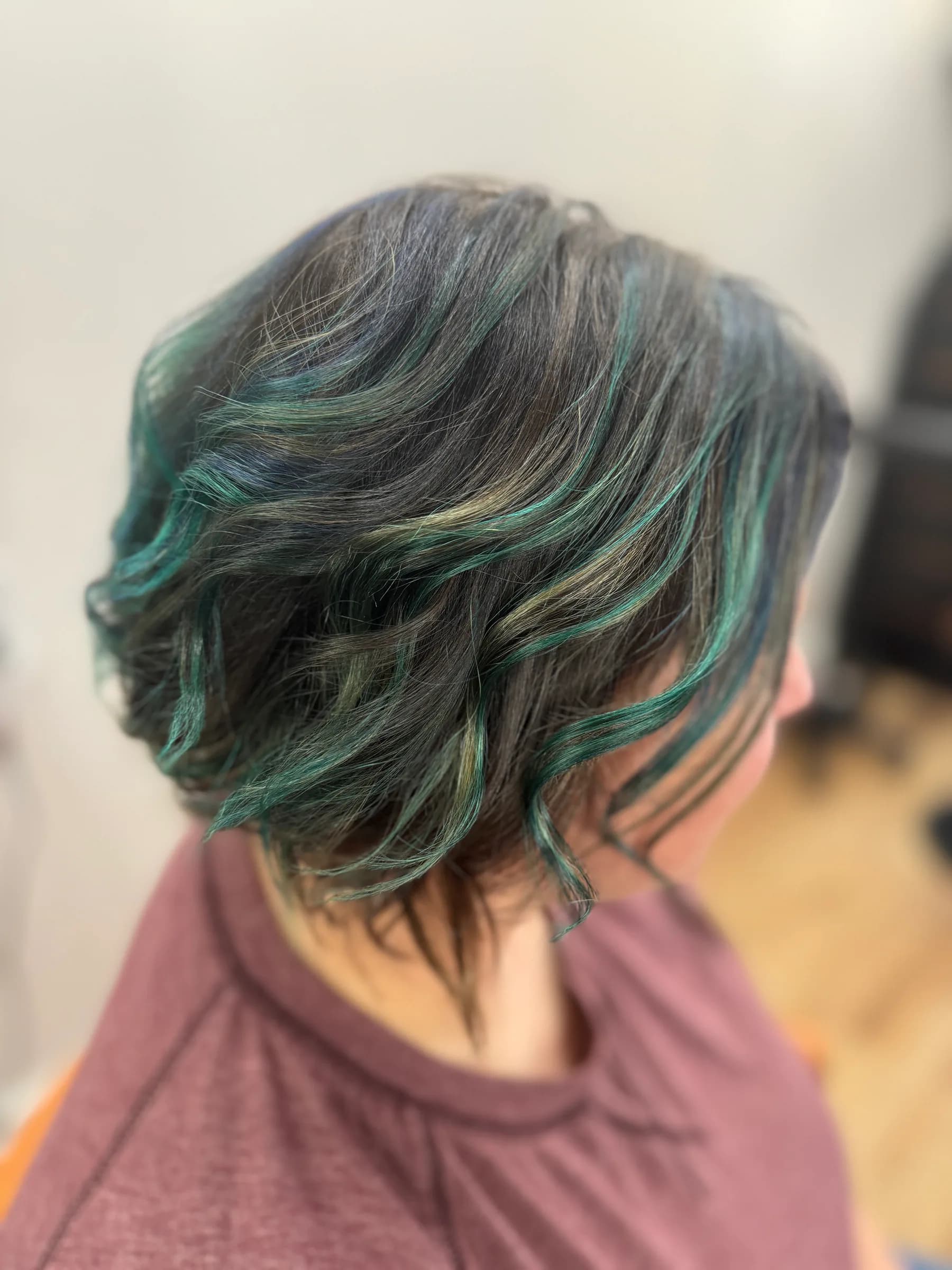 Short dark hair with teal colour accents